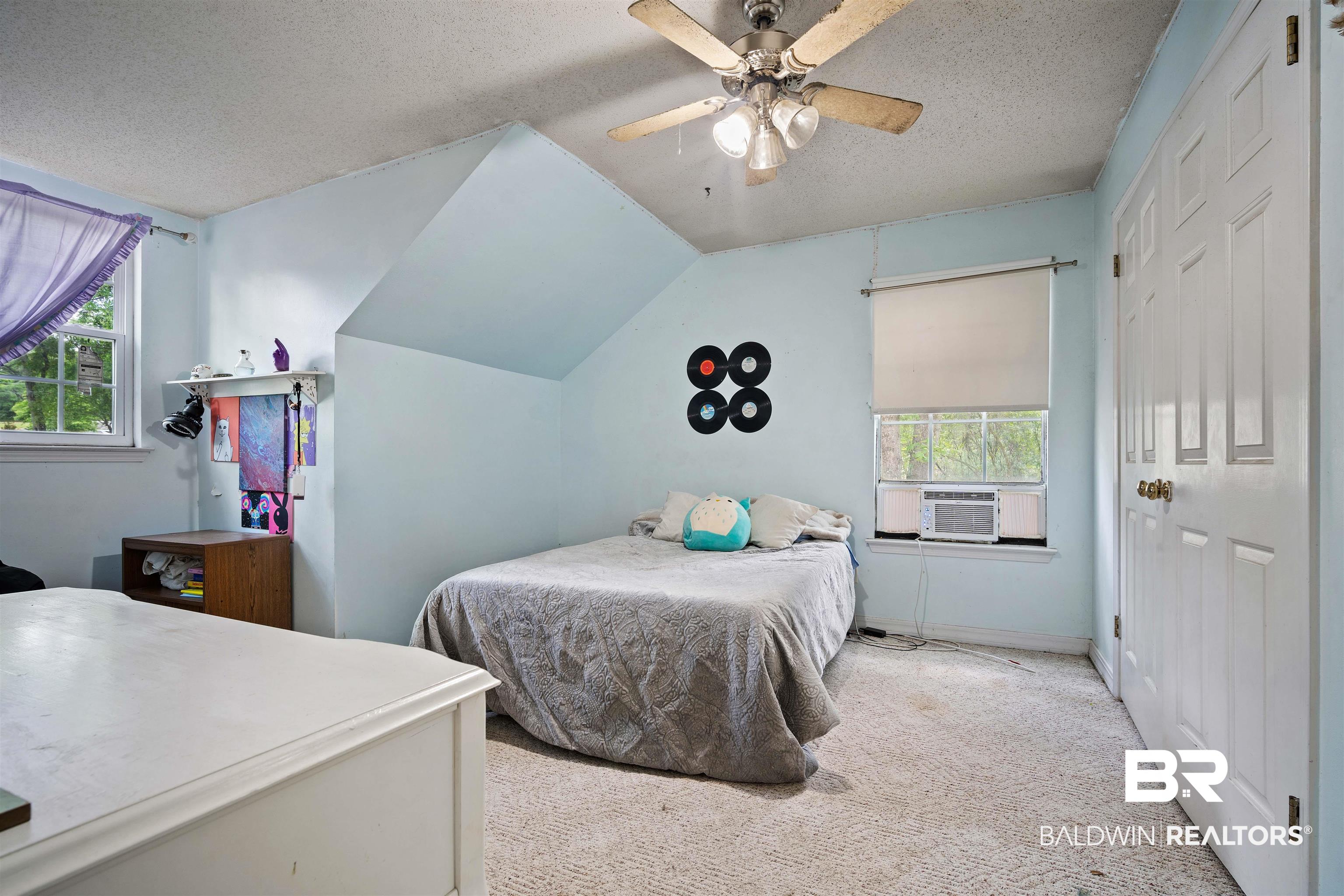 2823 Woodland Road Mobile, AL 36693 - Photo 15 of 29 Carpeted bedroom featuring ceiling fan, a textured ceiling, cooling unit, and multiple windows
