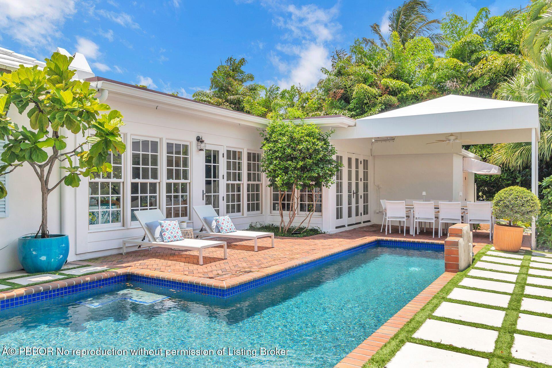 255 Colonial Lane Palm Beach, FL 33480 - Photo 26 of 32 a view of a house with swimming pool and porch with a chairs