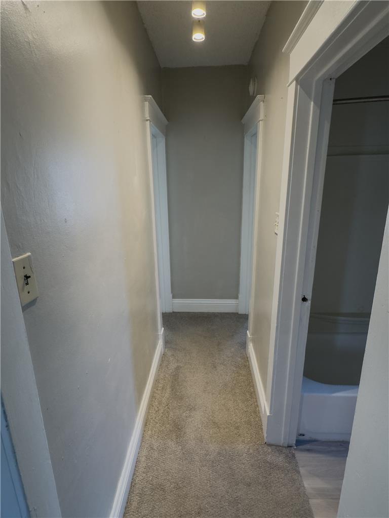 870 Chestnut Street Coplay, PA 18037 - Photo 10 of 24 Well-lit hallway with plush carpet provides seamless access to adjoining rooms.