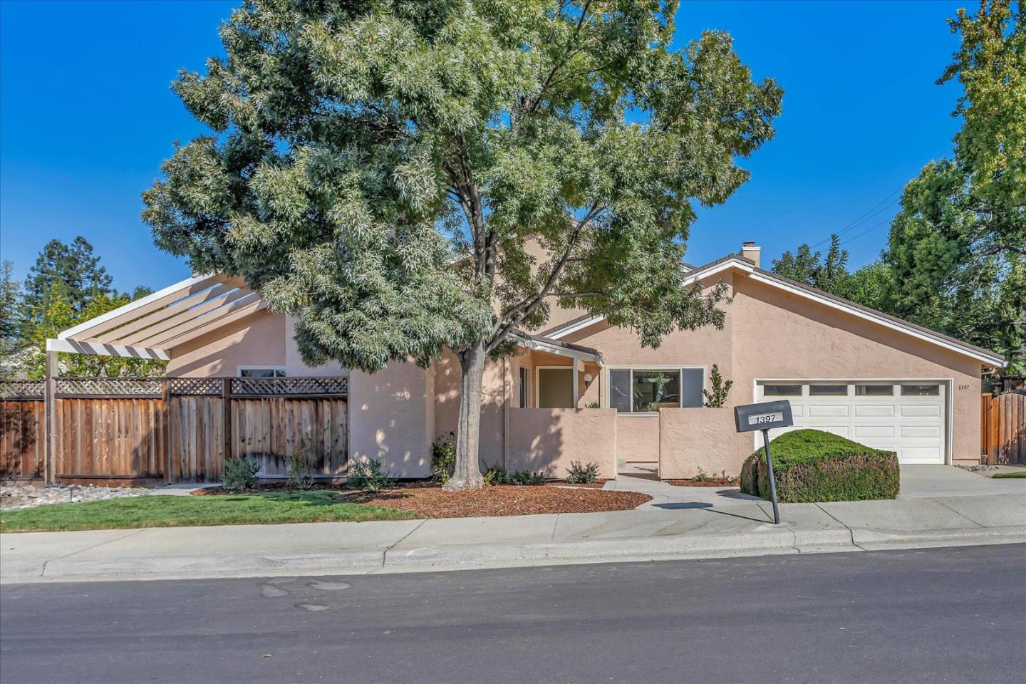 a front view of a house with a garden and garage
