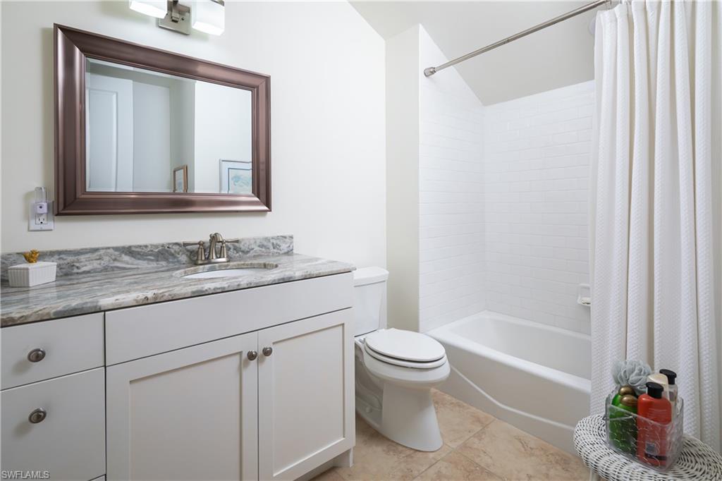 485 Wedge Drive Naples, FL 34103 - Photo 15 of 25 a bathroom with a granite countertop sink toilet and shower