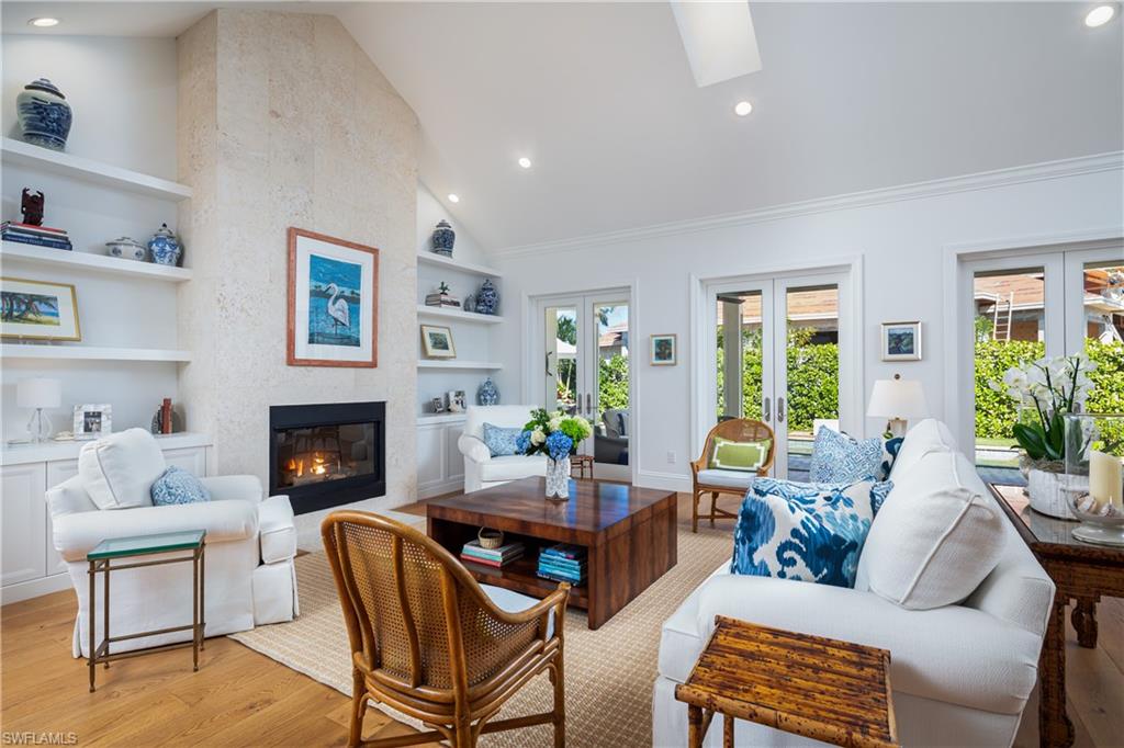 485 Wedge Drive Naples, FL 34103 - Photo 2 of 25 a living room with furniture and a fireplace