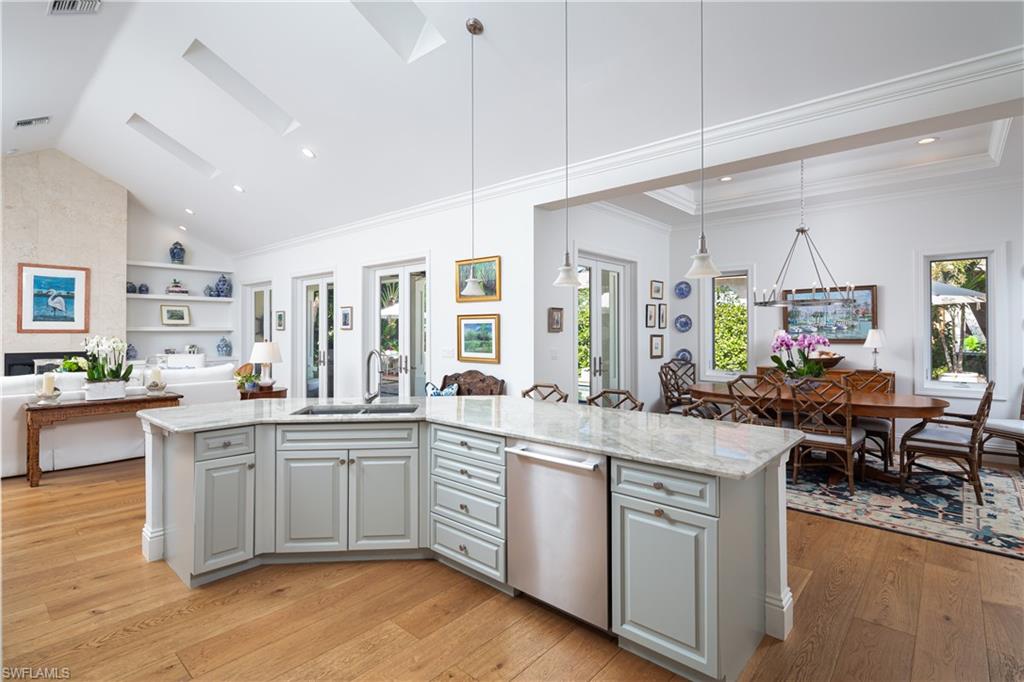 485 Wedge Drive Naples, FL 34103 - Photo 7 of 25 a kitchen with lots of counter top space and painting on the wall