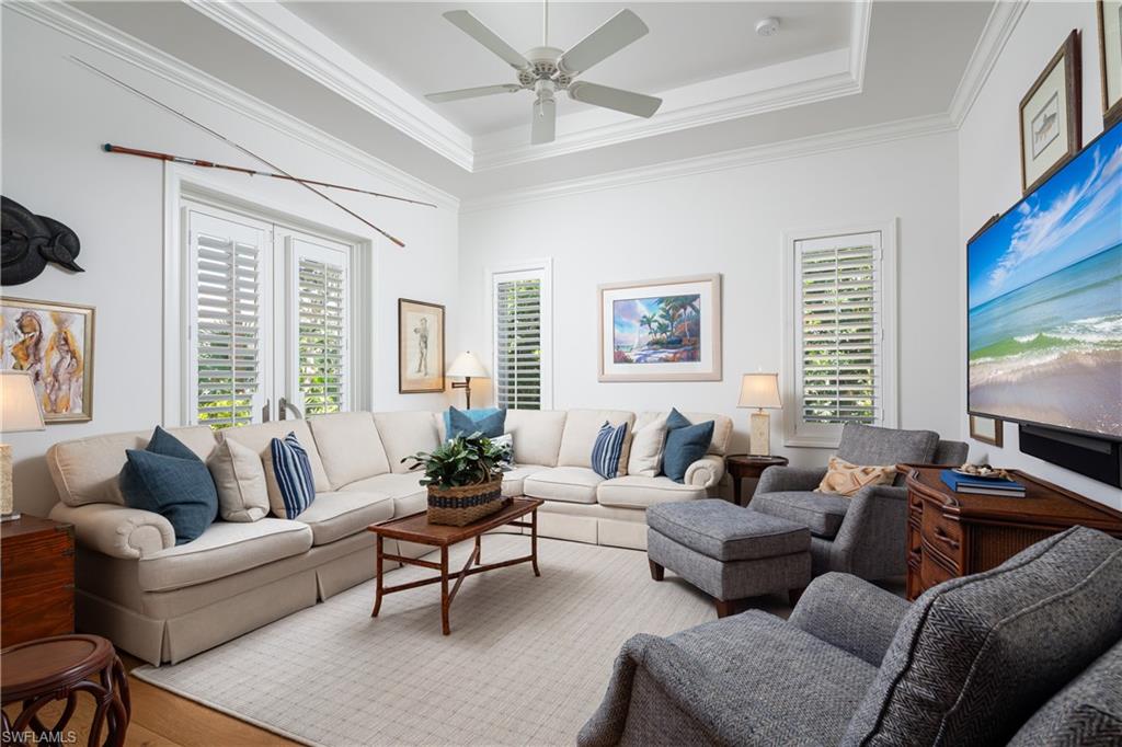 485 Wedge Drive Naples, FL 34103 - Photo 9 of 25 a living room with furniture ceiling fan and a window