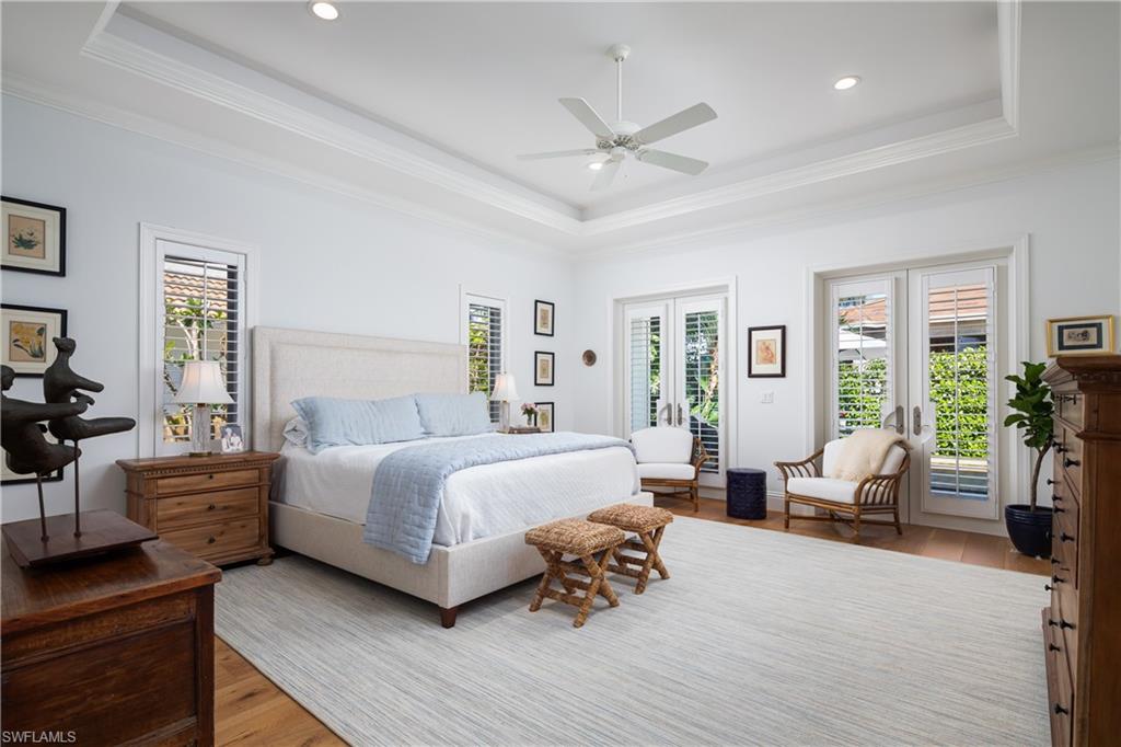 485 Wedge Drive Naples, FL 34103 - Photo 10 of 25 a bedroom with a bed couches and potted plant on the dresser