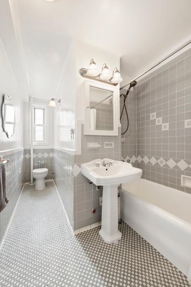 70 Remsen Street, Unit 7H Brooklyn, NY 11201 - Photo 10 of 13 a bathroom with a sink a toilet and shower