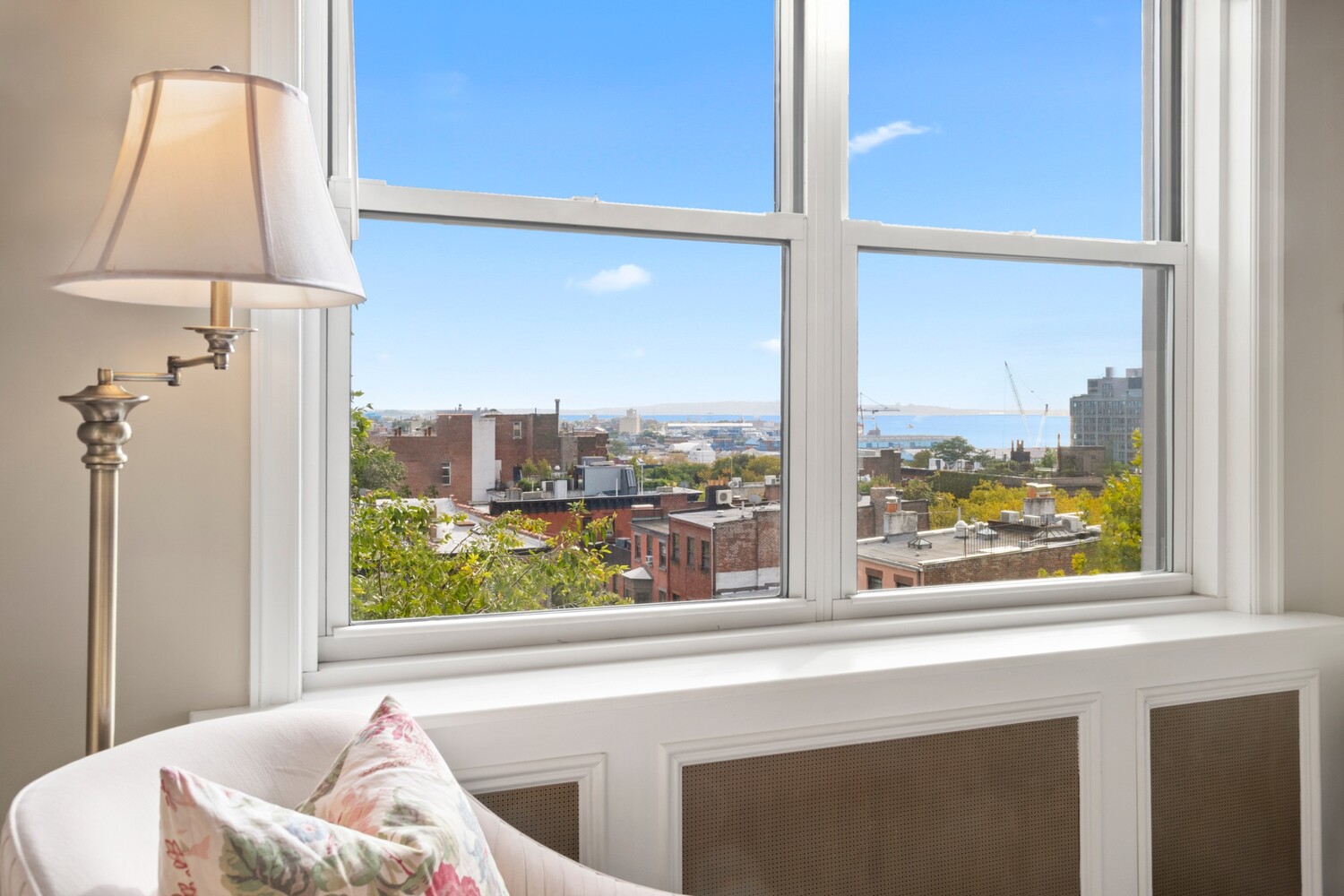 70 Remsen Street, Unit 7H Brooklyn, NY 11201 - Photo 9 of 13 a living room with a large window and a table