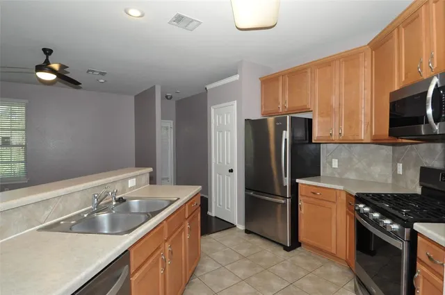 a kitchen with a sink appliances and cabinets