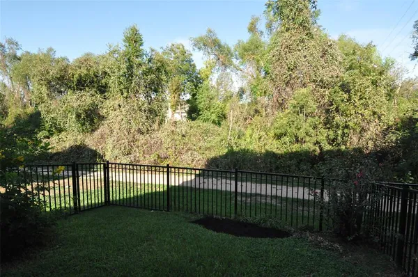 a view of a yard and a fence