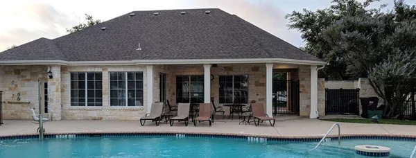 a front view of a house with a yard fire pit and outdoor seating