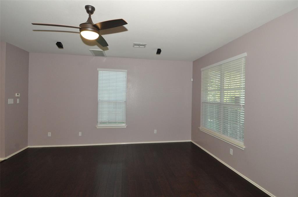 1900 Scofield Ridge Parkway, Unit 5403 Austin, TX 78727 - Photo 5 of 30 an empty room with wooden floor and windows