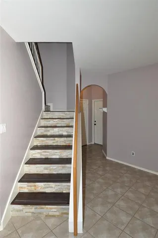 a room with a chandelier fan and a window