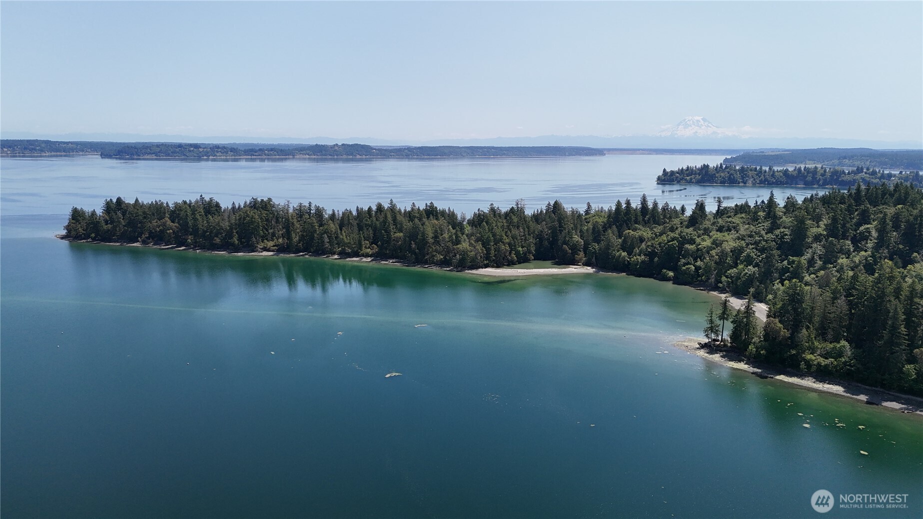 18771 Erickson Road Southwest Longbranch, WA 98349 - Photo 6 of 9 a view of lake with green space
