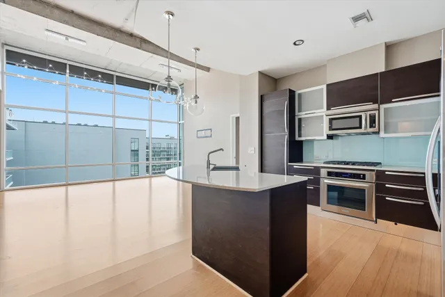 a kitchen with stainless steel appliances a stove and cabinets