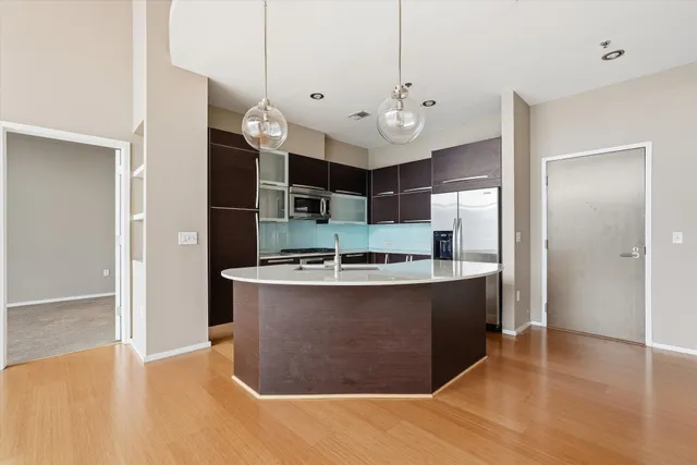 a kitchen with stainless steel appliances granite countertop a refrigerator and a stove