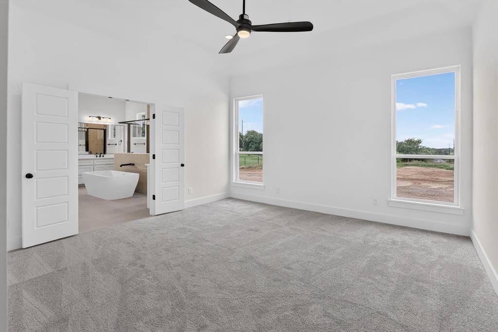 471 Red Bird Drive Springtown, TX 76082 - Photo 17 of 35 Spacious room featuring light gray carpeting and white walls