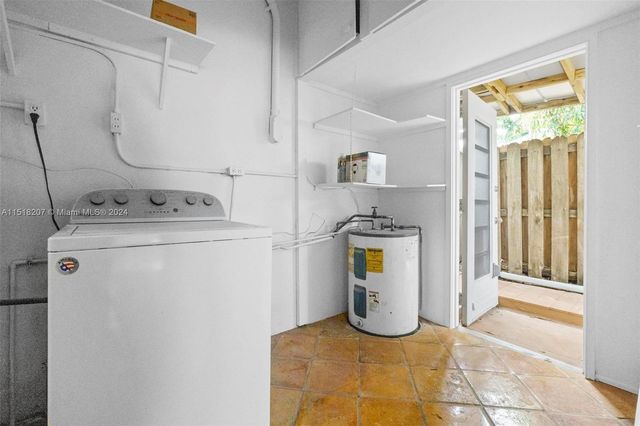 a view of walk in closet with empty room