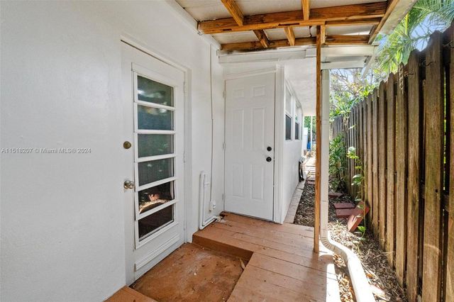 a view of a livingroom with a hall and wooden floor