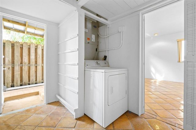 a view of empty room with wooden floor and window