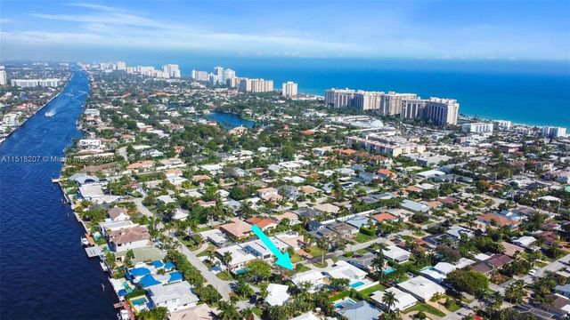 aerial view of a house with plants next to a yard