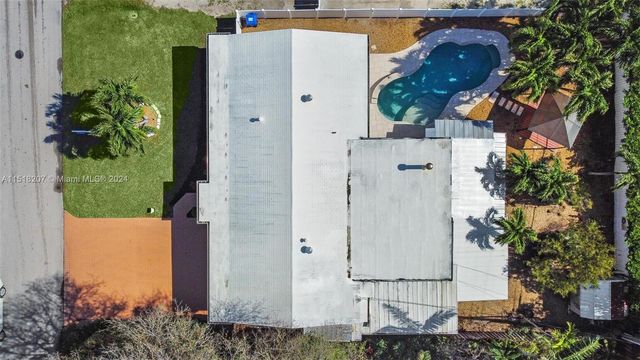 an aerial view of a house with a yard and garden