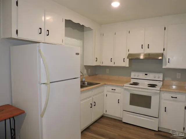 a white refrigerator freezer sitting inside of a kitchen