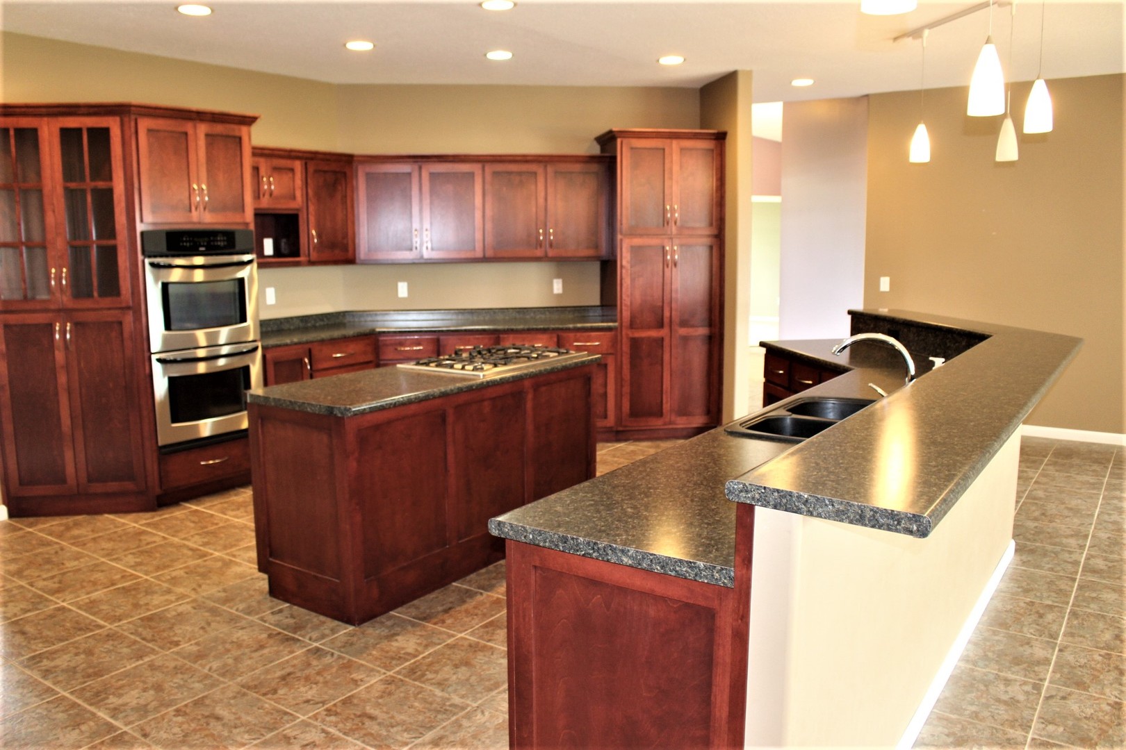 3978 Connors Road Clinton, IL 61727 - Photo 2 of 34 a kitchen with stainless steel appliances granite countertop a stove a refrigerator and a sink