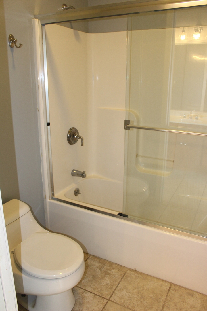 3978 Connors Road Clinton, IL 61727 - Photo 24 of 34 a bathroom with a shower and a toilet