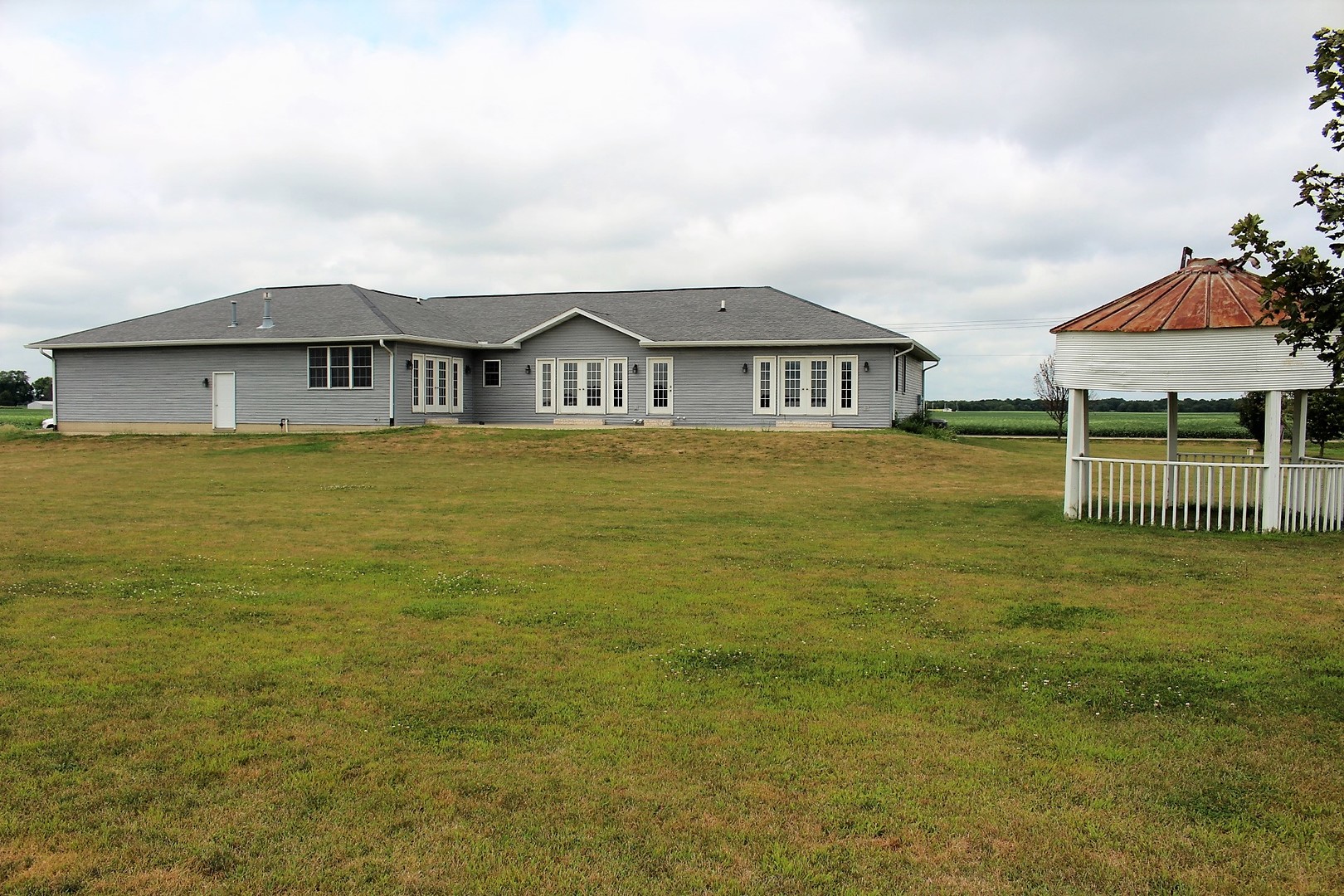 3978 Connors Road Clinton, IL 61727 - Photo 30 of 34 a front view of a house with a garden