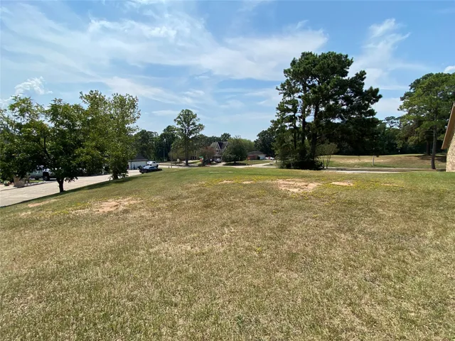a view of outdoor space with playground and green space