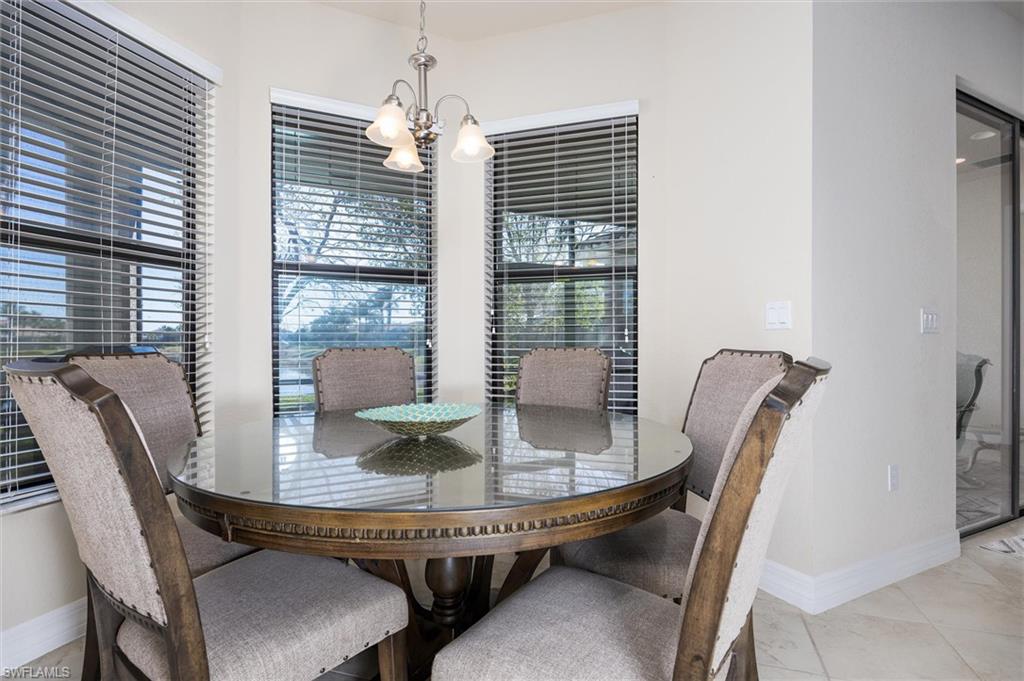 3296 Pacific Drive Naples, FL 34119 - Photo 17 of 50 a dining room with furniture and window
