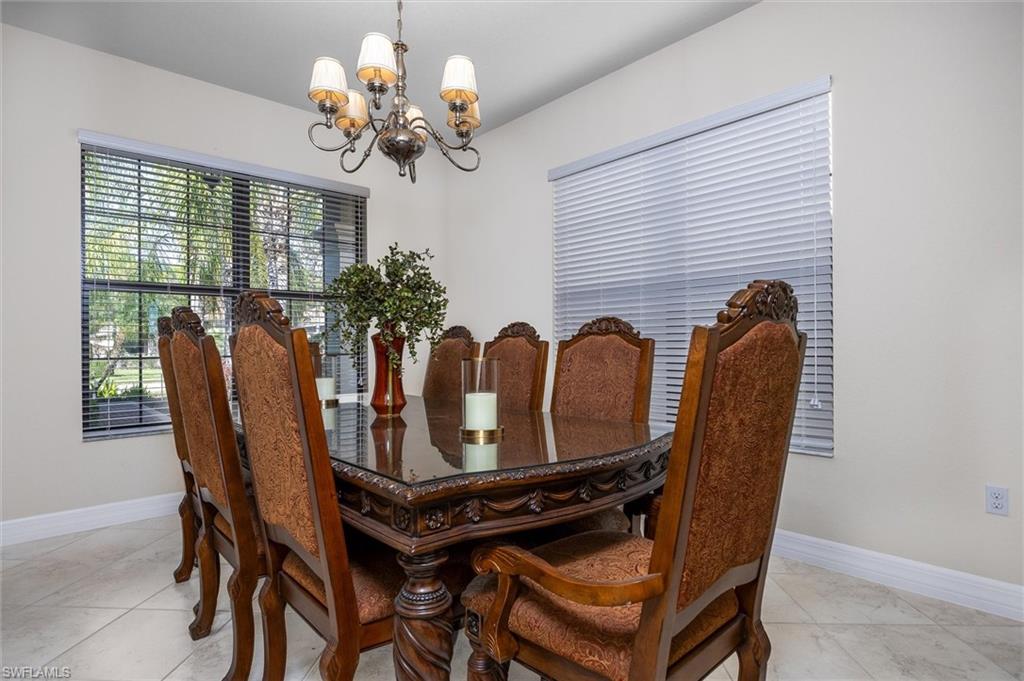 3296 Pacific Drive Naples, FL 34119 - Photo 18 of 50 a view of a dining room with furniture and chandelier
