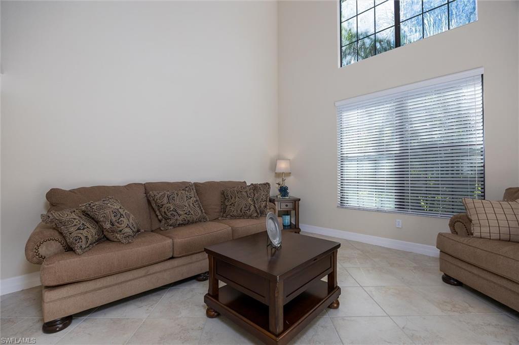 3296 Pacific Drive Naples, FL 34119 - Photo 19 of 50 a living room with furniture and a window