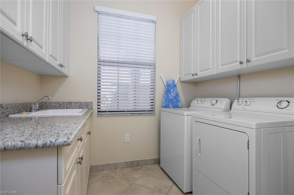 3296 Pacific Drive Naples, FL 34119 - Photo 21 of 50 a utility room with a sink washer and dryer