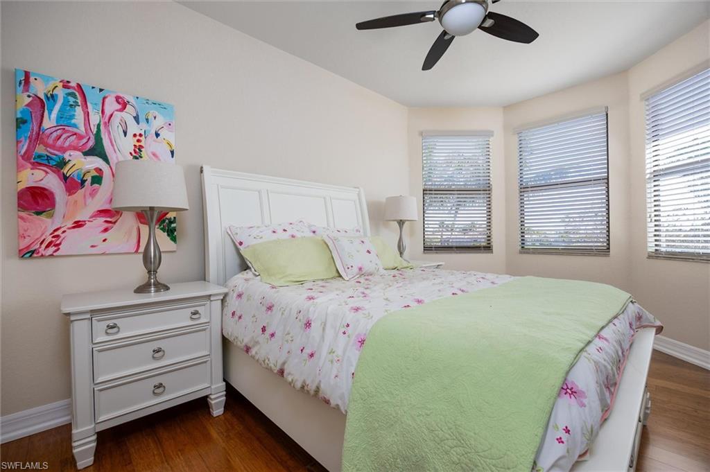 3296 Pacific Drive Naples, FL 34119 - Photo 24 of 50 a bedroom with a bed and a window