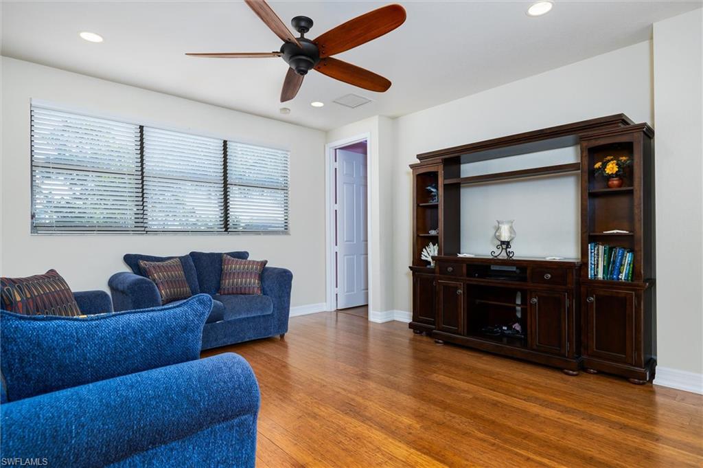3296 Pacific Drive Naples, FL 34119 - Photo 26 of 50 a living room with furniture and a flat screen tv