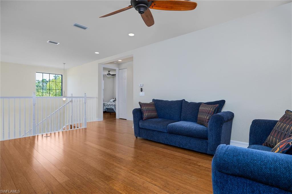 3296 Pacific Drive Naples, FL 34119 - Photo 27 of 50 a living room with furniture and a wooden floor