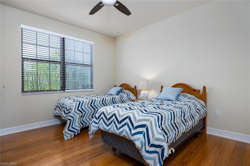3296 Pacific Drive Naples, FL 34119 - Photo 28 of 50 a bedroom with two beds and wooden floor