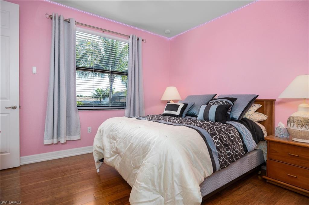 3296 Pacific Drive Naples, FL 34119 - Photo 31 of 50 a bedroom with a bed and a window