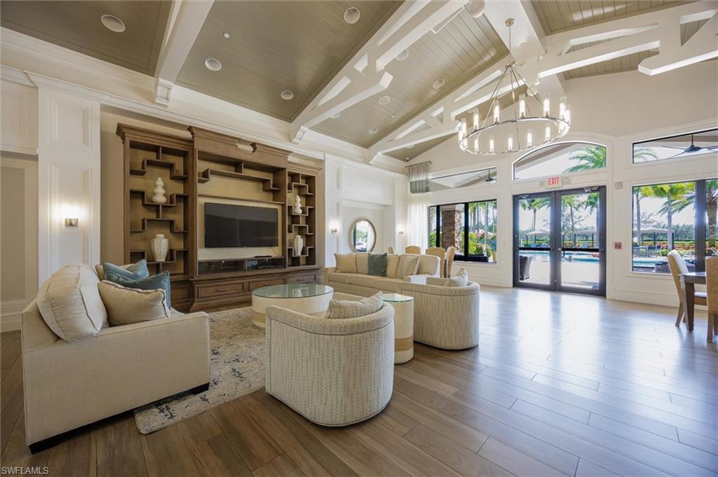 3296 Pacific Drive Naples, FL 34119 - Photo 35 of 50 a living room with furniture and a flat screen tv