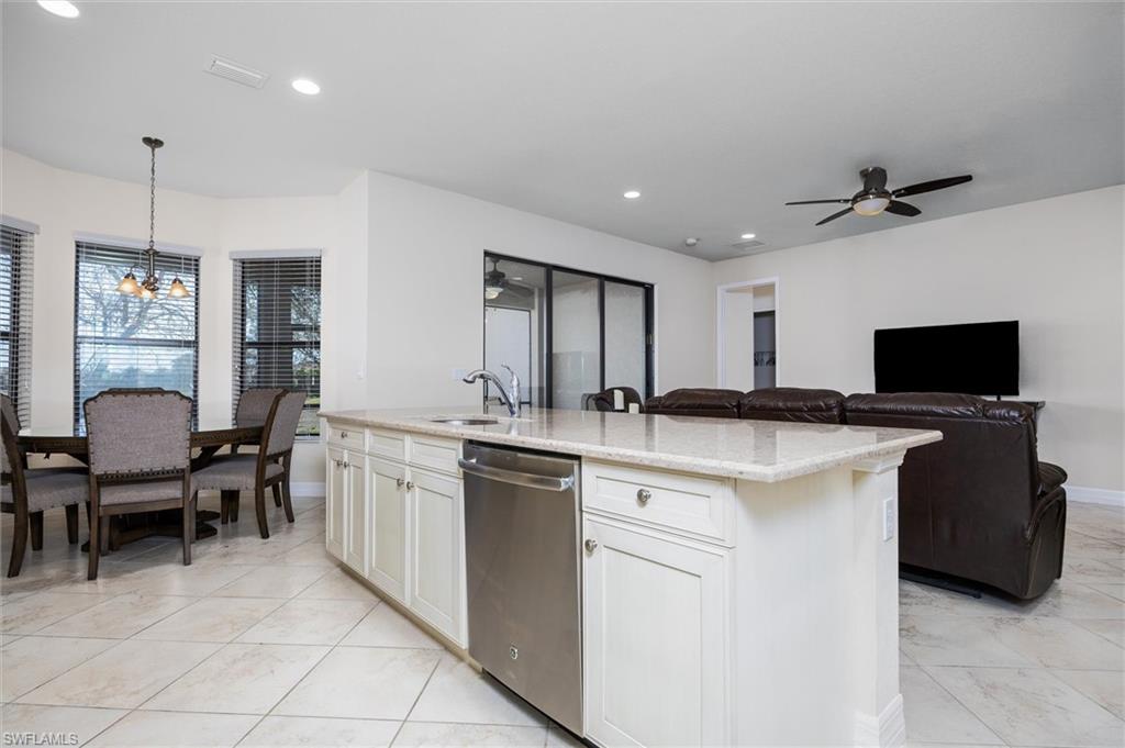 3296 Pacific Drive Naples, FL 34119 - Photo 50 of 50 a kitchen with a sink and a refrigerator