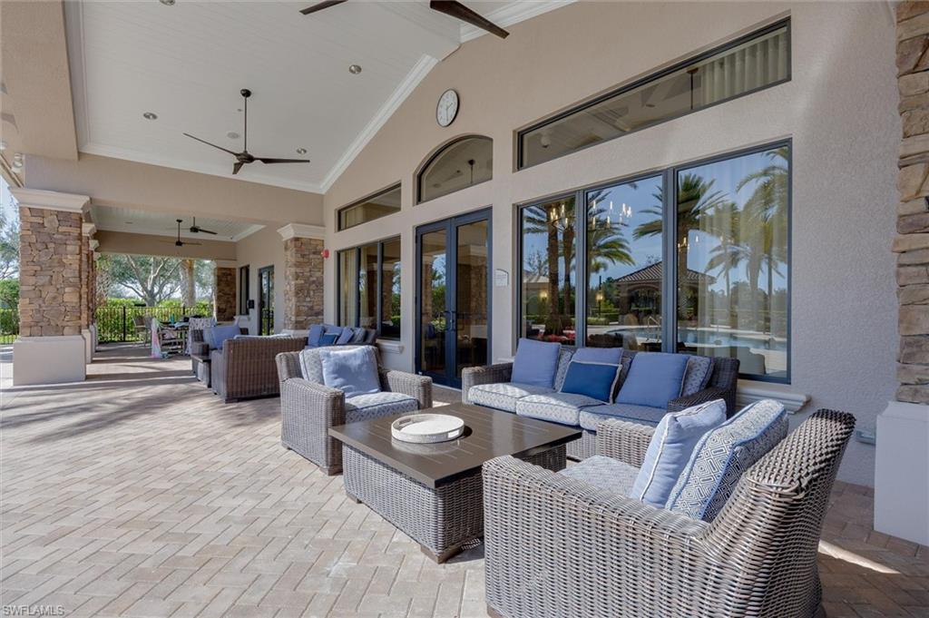 3296 Pacific Drive Naples, FL 34119 - Photo 40 of 50 a living room with patio furniture and a large window