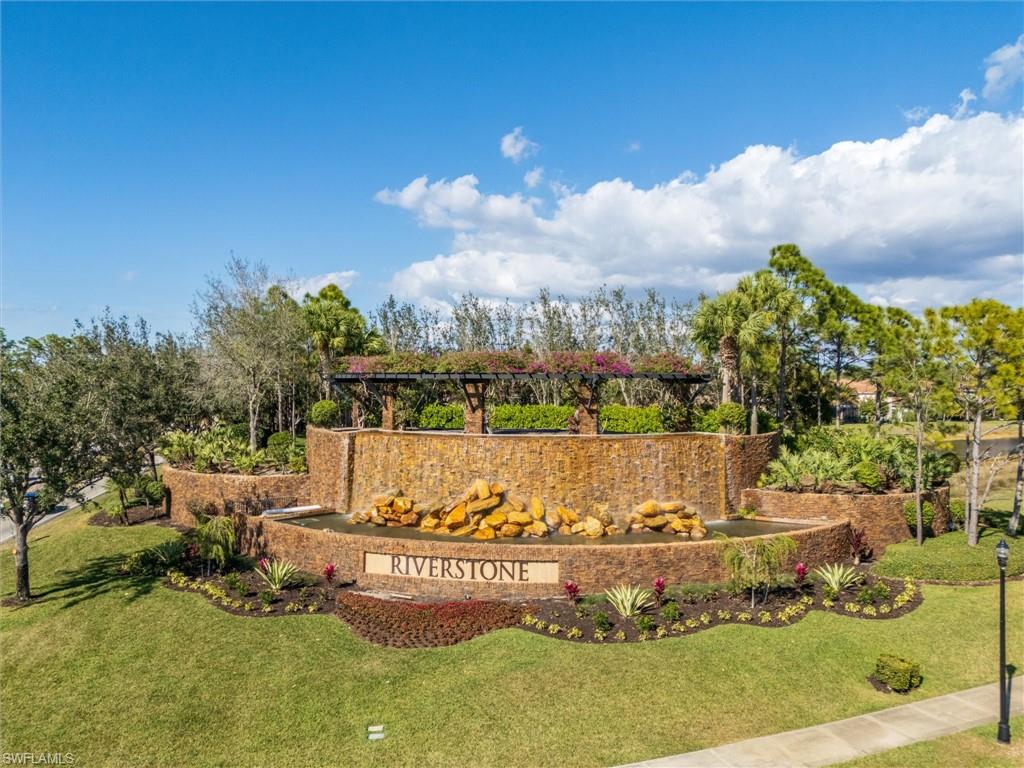 3296 Pacific Drive Naples, FL 34119 - Photo 48 of 50 a view of a water pond with large trees
