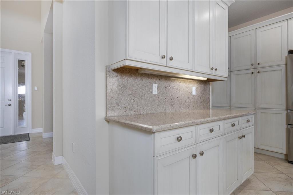 3296 Pacific Drive Naples, FL 34119 - Photo 5 of 50 a view of a kitchen with white cabinets