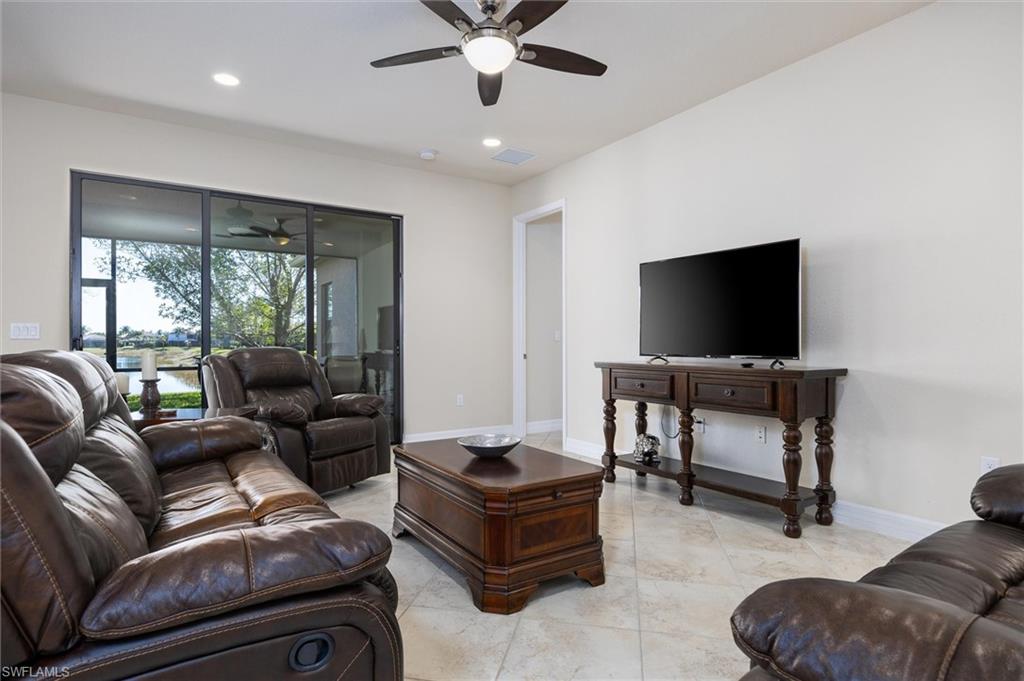 3296 Pacific Drive Naples, FL 34119 - Photo 6 of 50 a living room with furniture and a flat screen tv