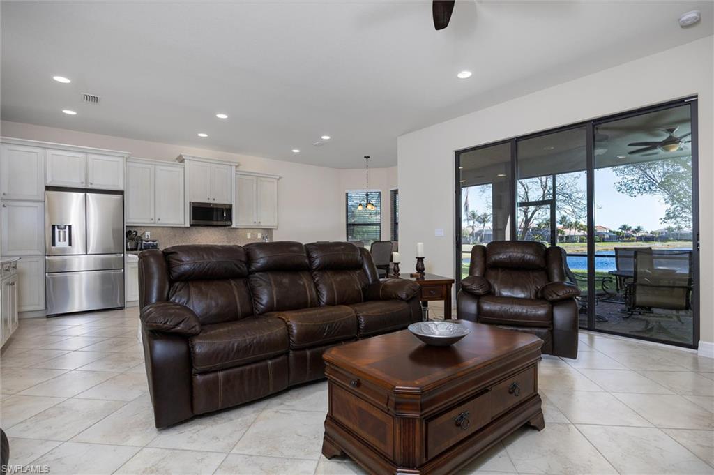 3296 Pacific Drive Naples, FL 34119 - Photo 7 of 50 a living room with furniture and a floor to ceiling window