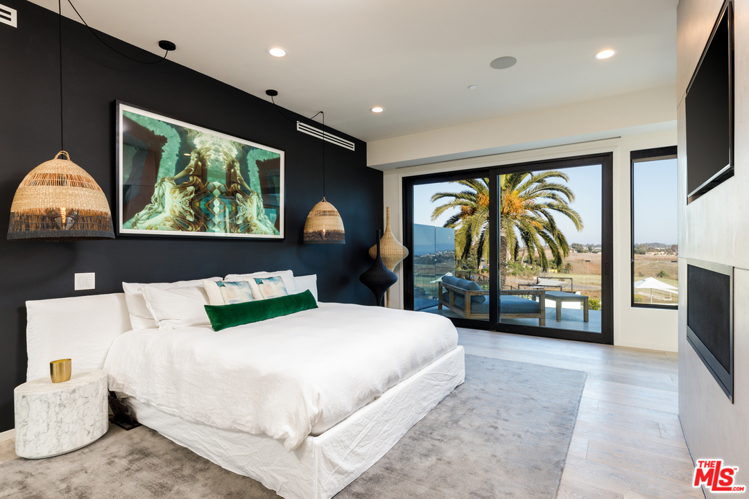 5944 Filaree Heights Road Malibu, CA 90265 - Photo 14 of 33 a bedroom with a large bed and a flat tv screen on dresser