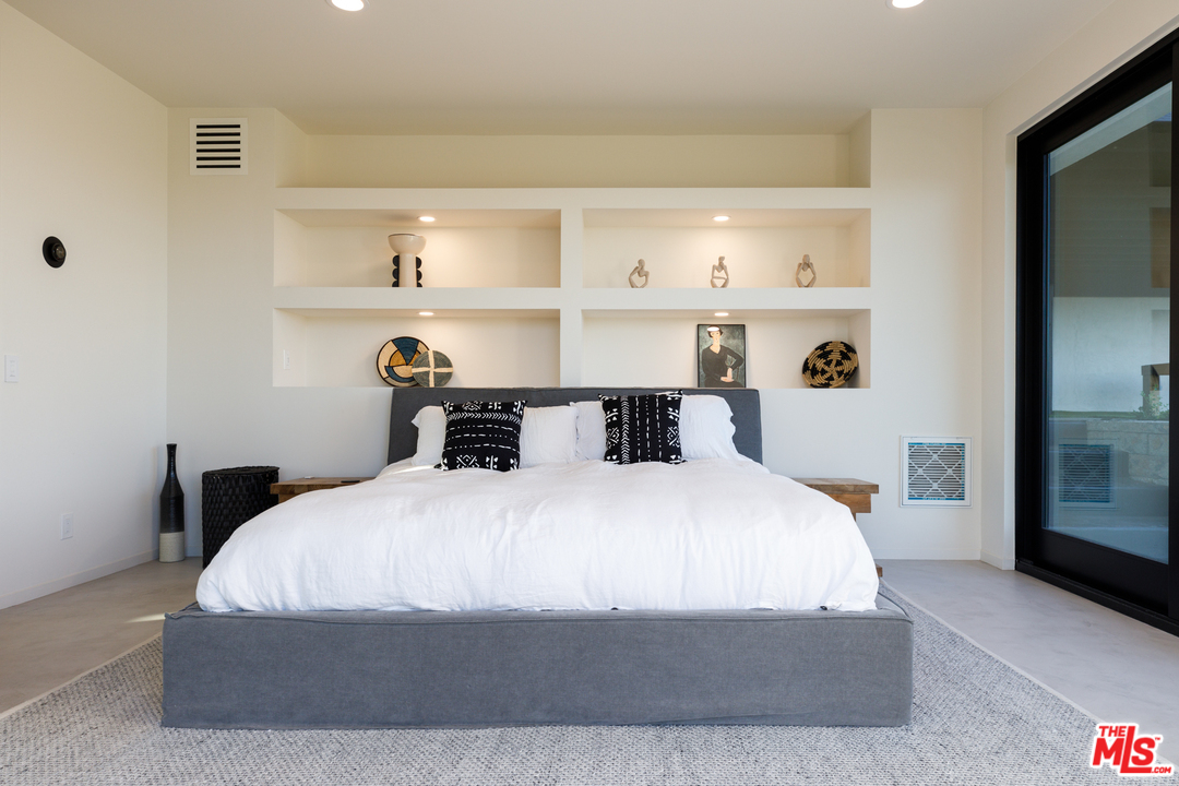 5944 Filaree Heights Road Malibu, CA 90265 - Photo 18 of 33 a bed sitting in a bedroom next to a window with kitchen