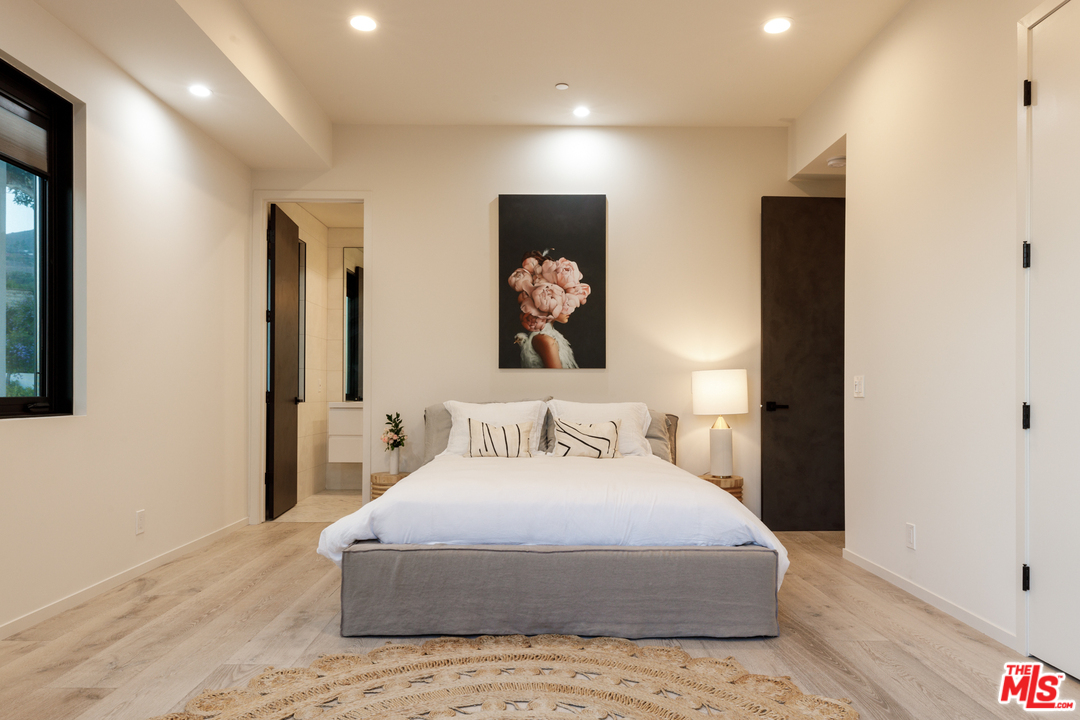5944 Filaree Heights Road Malibu, CA 90265 - Photo 22 of 33 a bedroom with a large bed and a painting