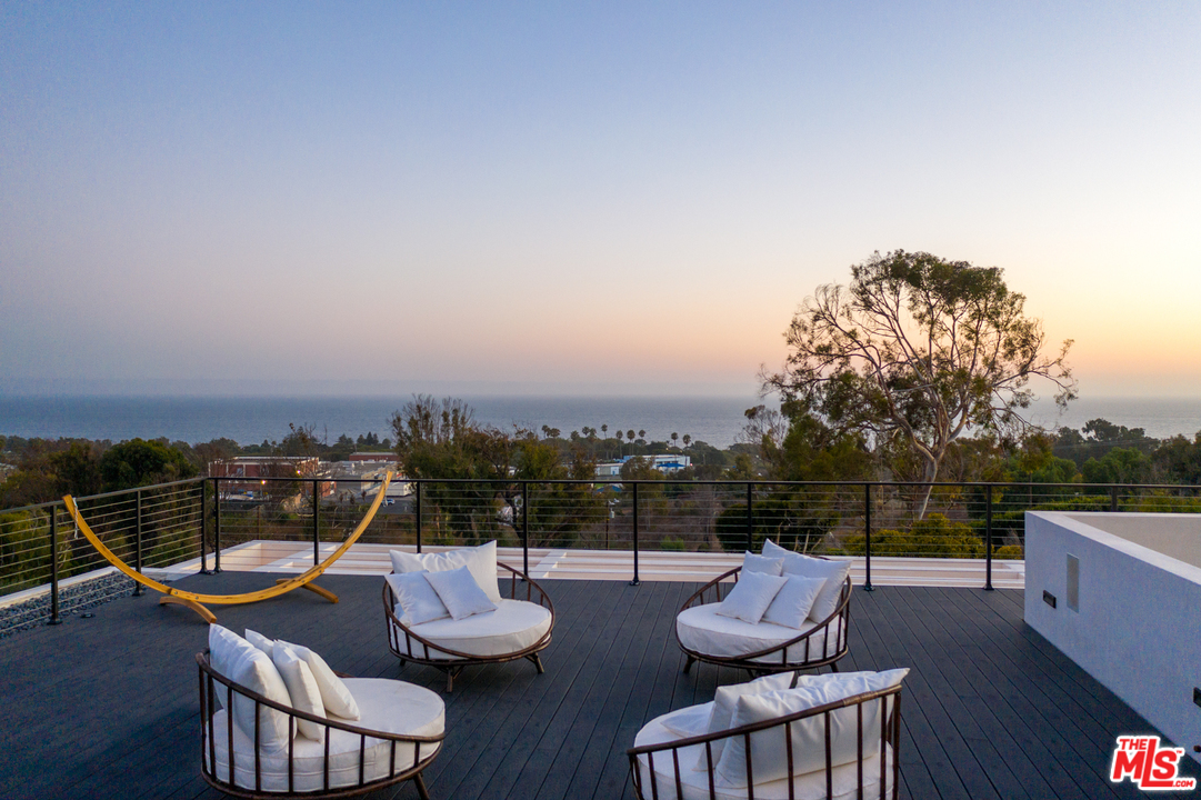 5944 Filaree Heights Road Malibu, CA 90265 - Photo 33 of 33 a view of a chair and tables on the roof deck